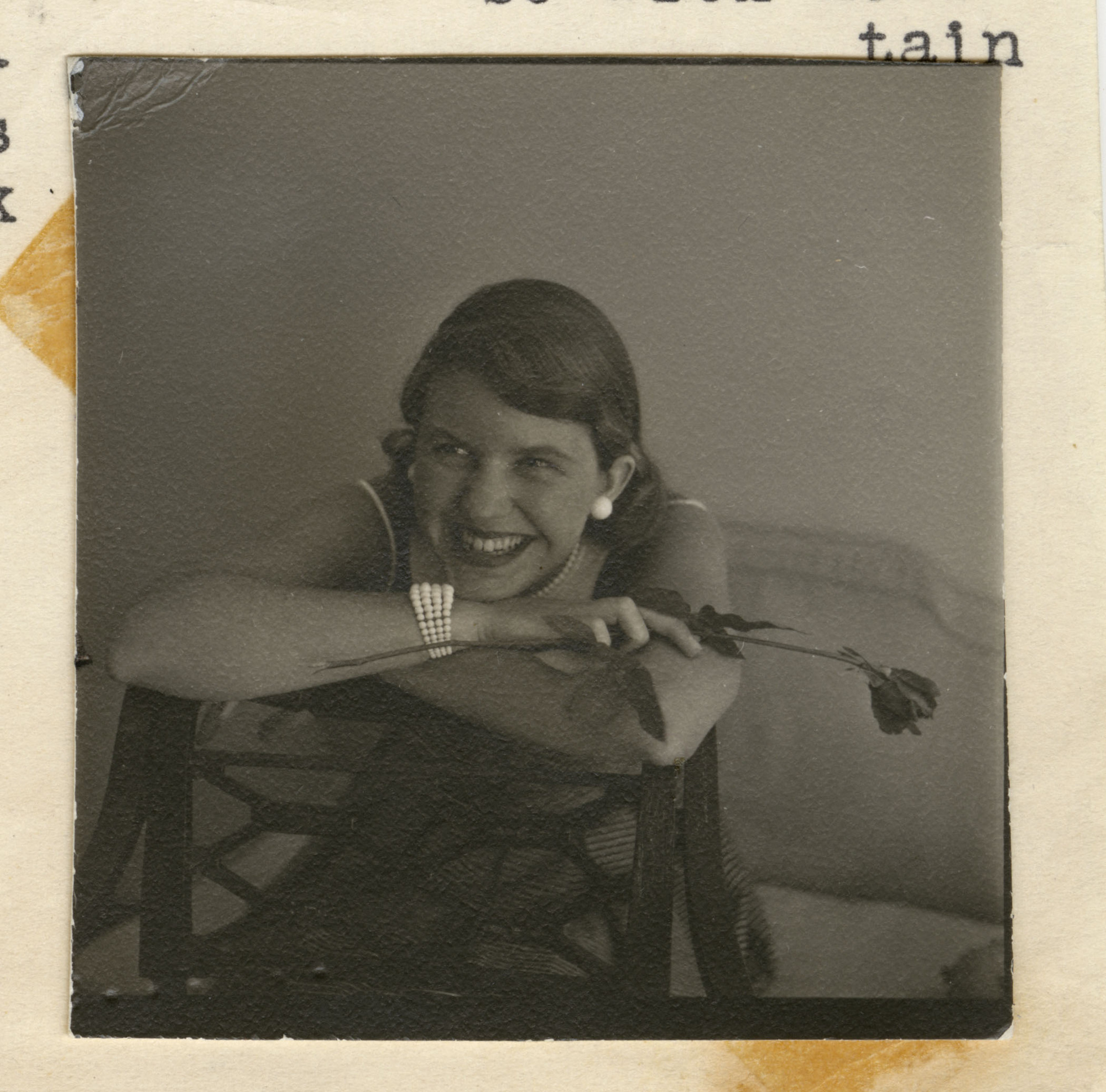 A black and white photo of Sylvia Plath holding a flower