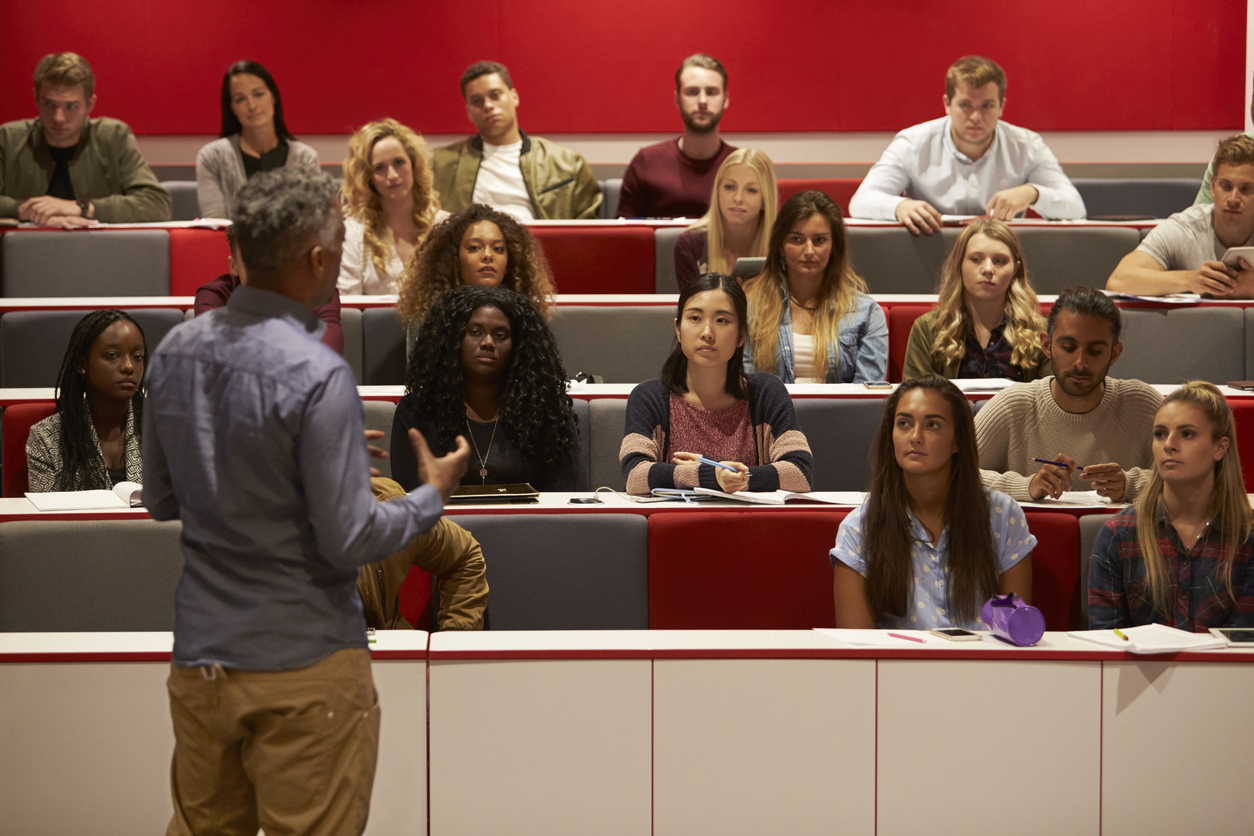 Lecturer presenting to students in an auditorium